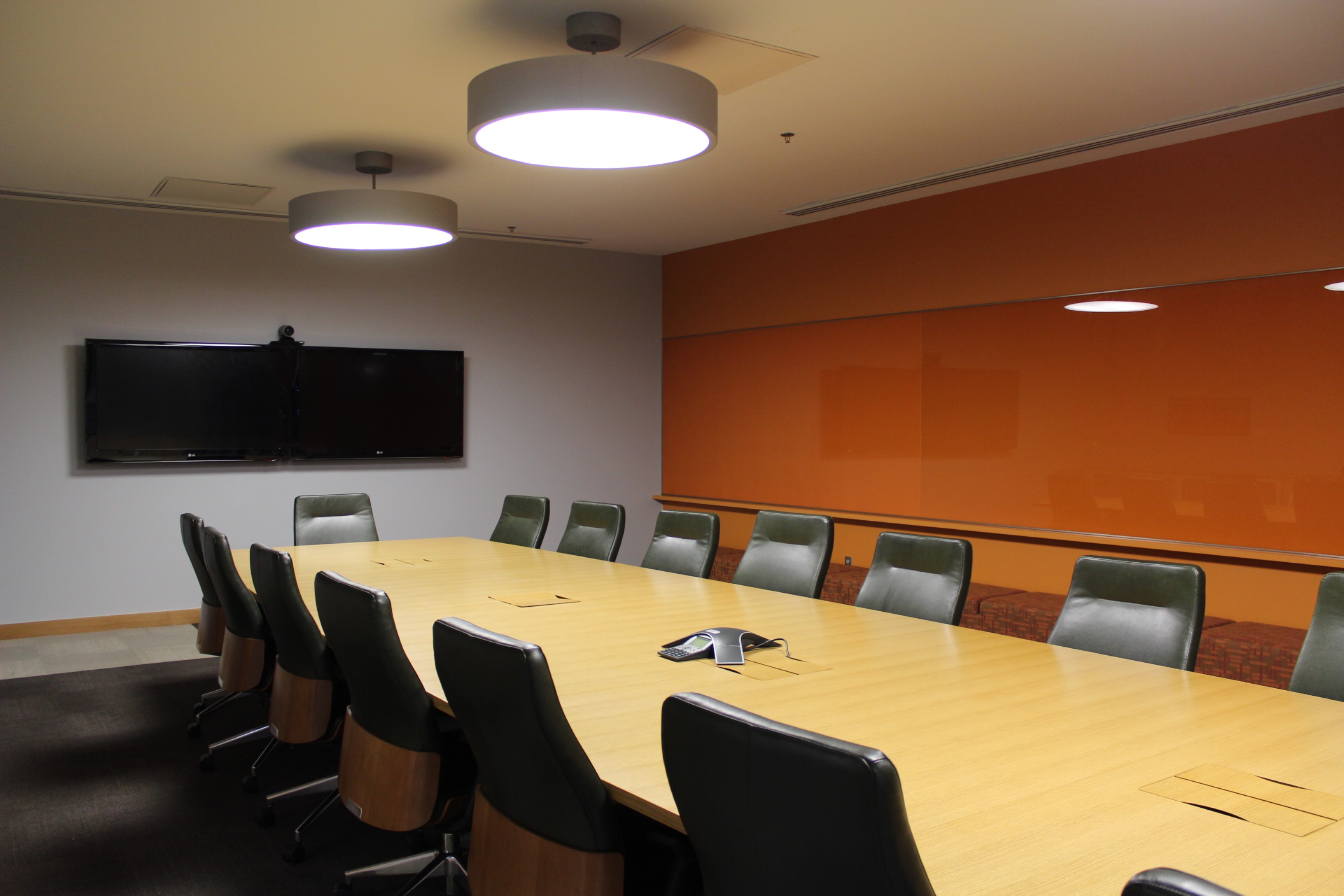 Board Room at Main Library featuring a large conference table, chairs, and audiovisual equipment for meetings and presentations.