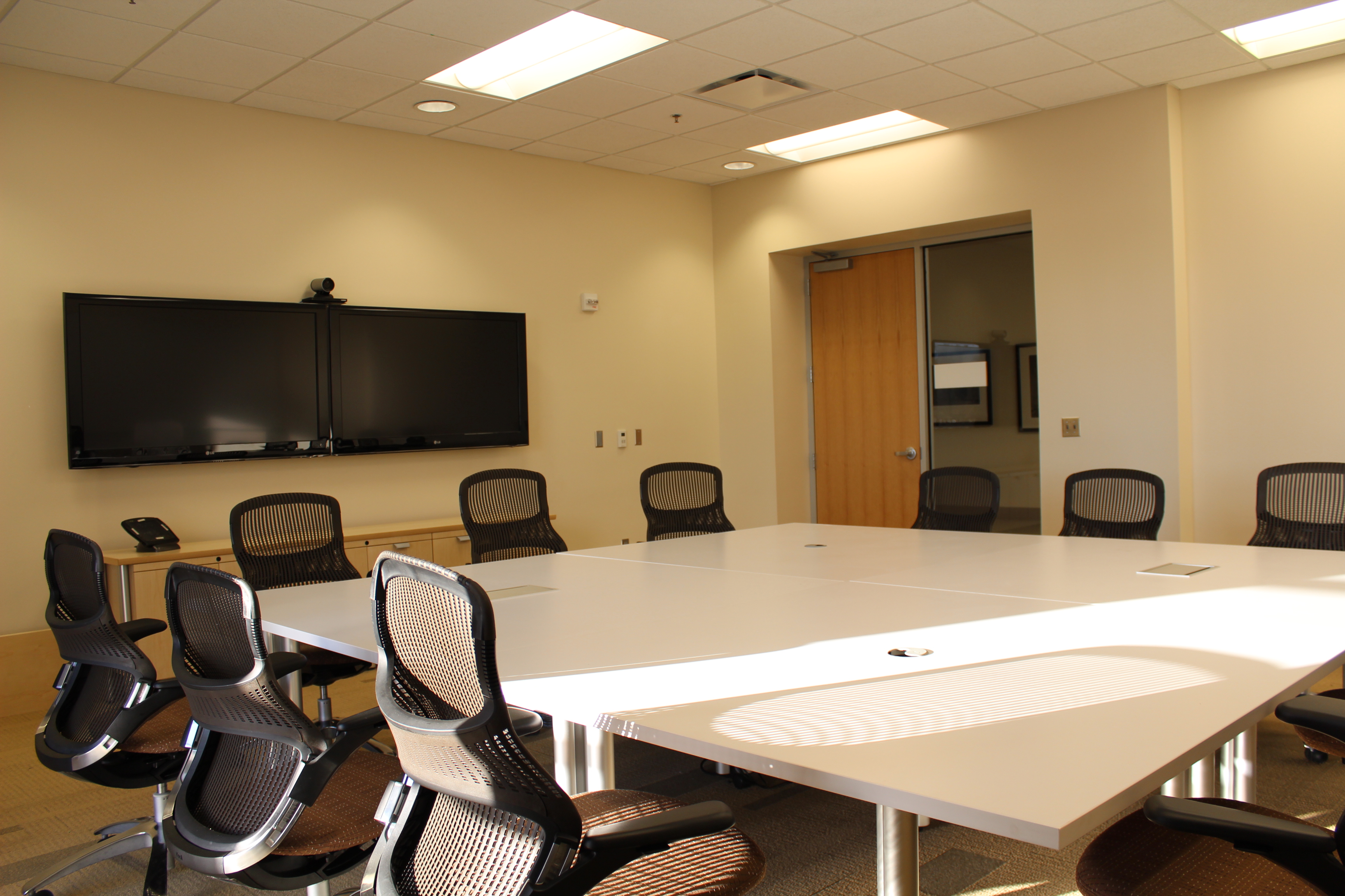 Conference Room B at Main Library featuring a conference table and seating for meetings, small group discussions, and collaborative work.