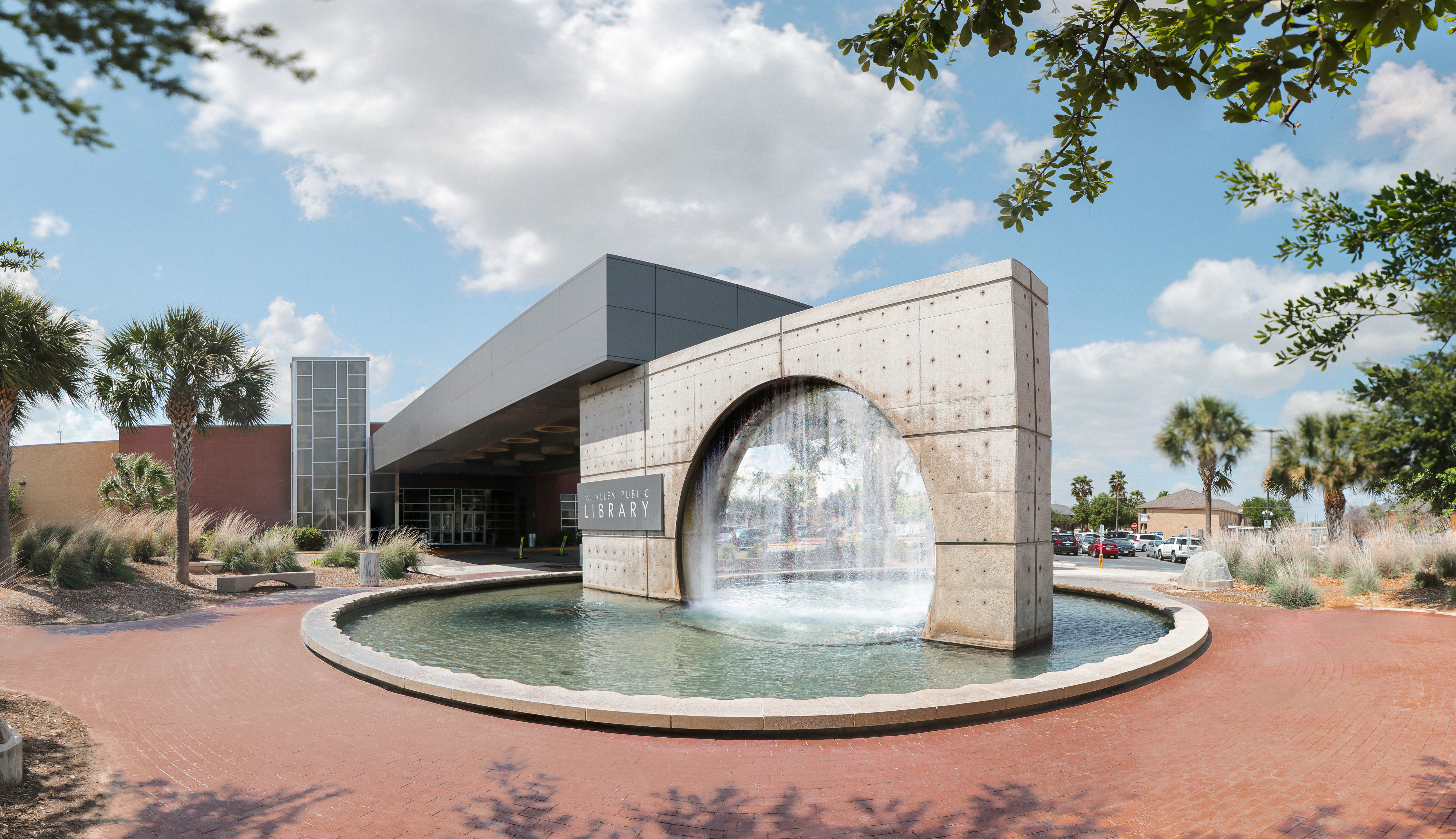Exterior view of Main Library featuring the iconic circular fountain at the entrance on a sunny day.